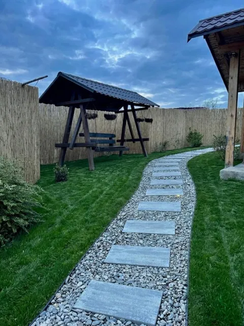 The stone path through the garden and the wooden swing