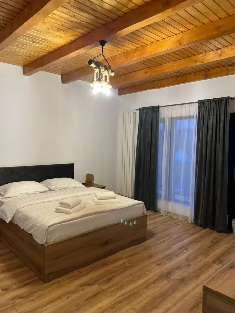 The double bed, next to the glass door to the terrace